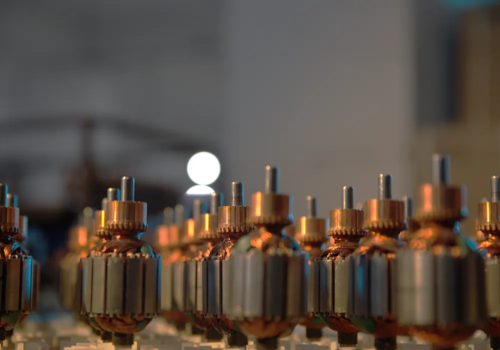 A row of copper-wound motor armatures