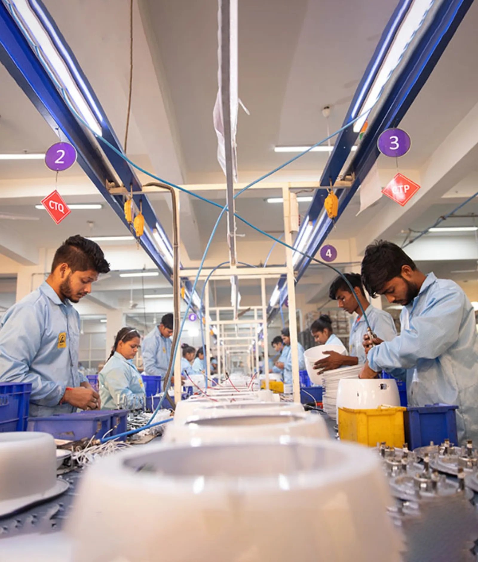 Technicians working along a Vardhman assembly line
